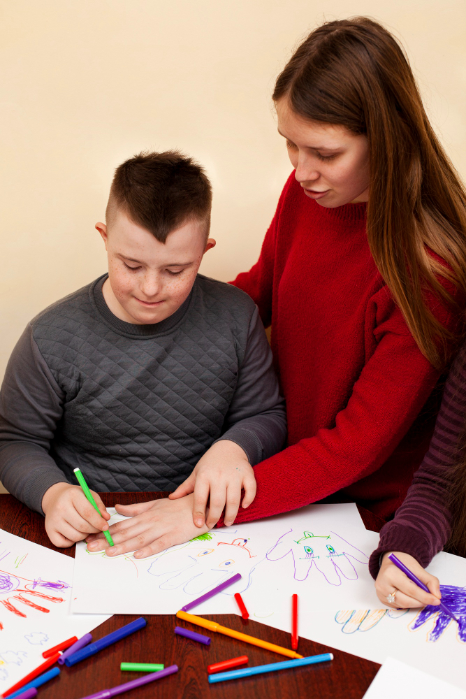 woman-helping-boy-with-down-syndrome-draw (1)